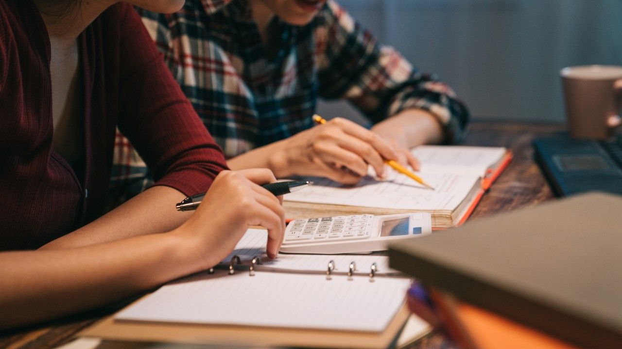 close-up-two-asian-female-doing-paperwork-modern-home-night-hard-working-teamwork-concept-young-girls-holding-pen-doing-project-prepare-exam-counting-calculator-secretary-test_0.jpg