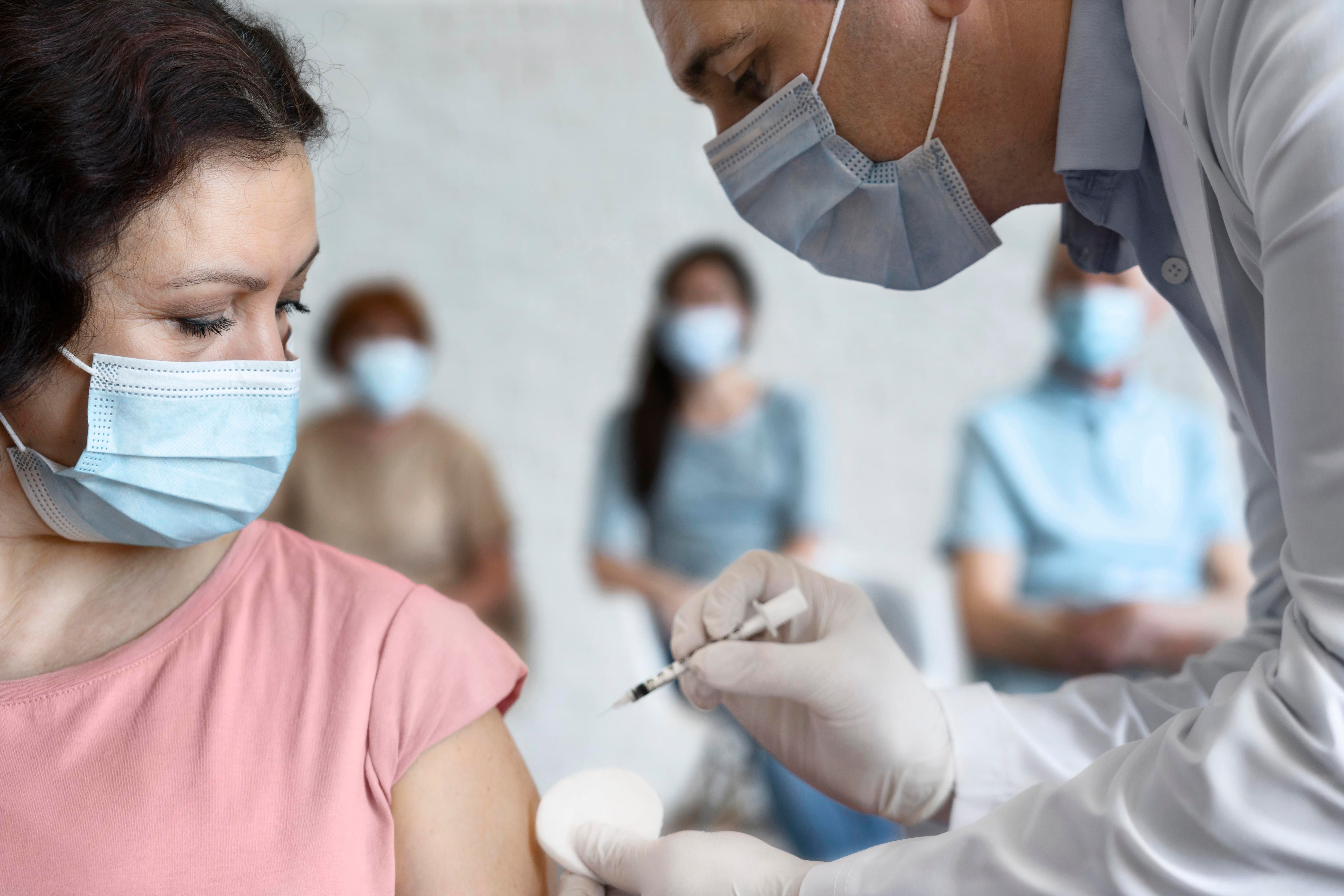 woman-getting-vaccine-shot-by-male-medic.jpg