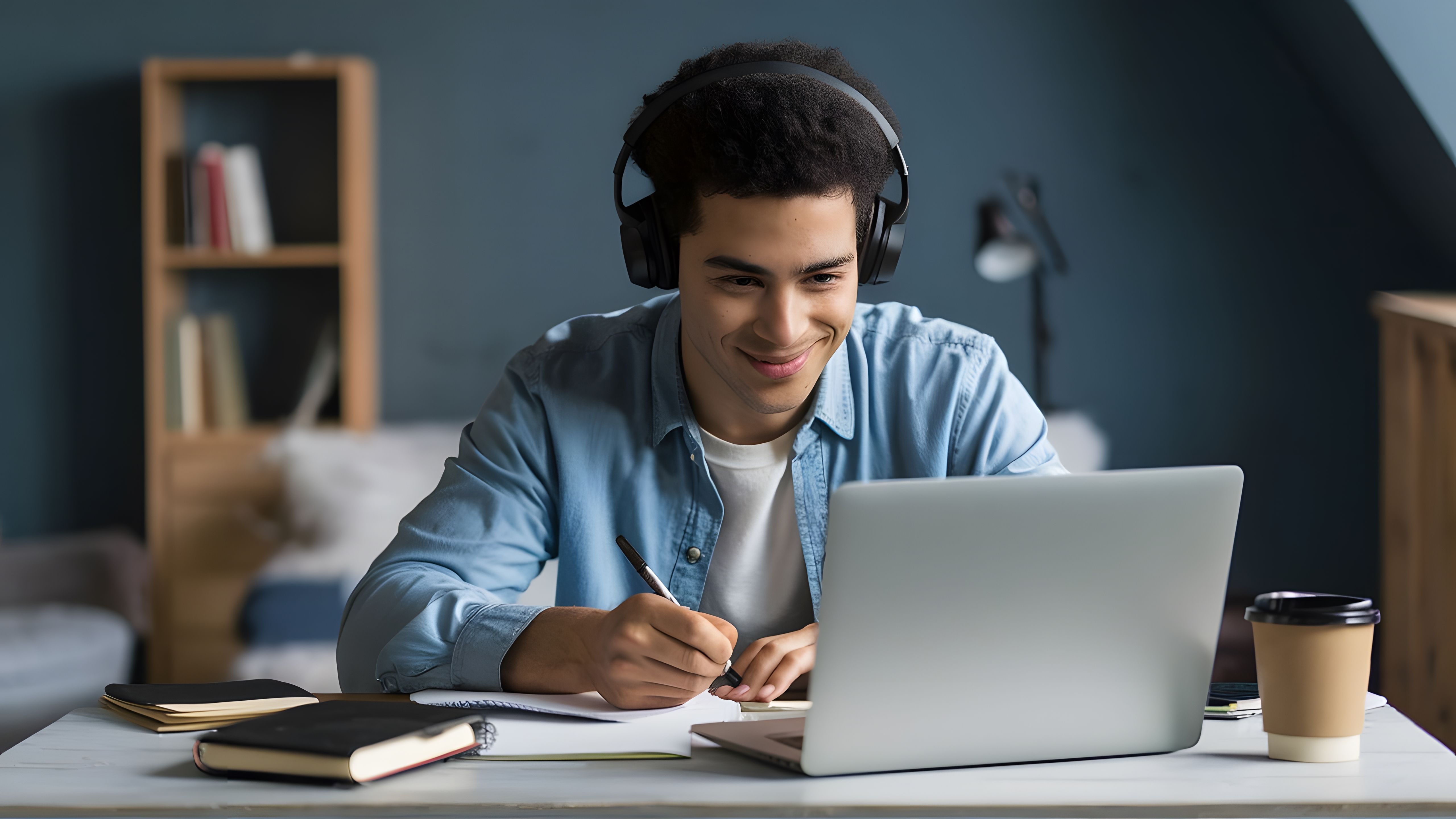 man-is-using-laptop-he-is-wearing-headphones.jpg